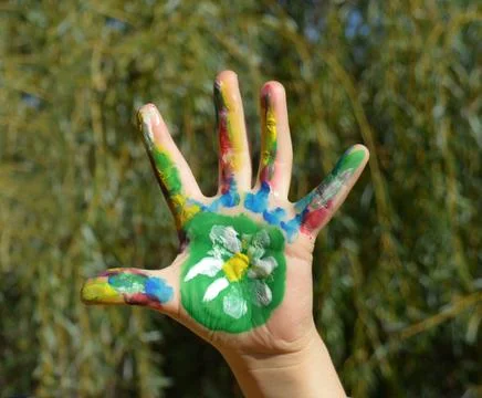 Painted kid hand Stock Photos