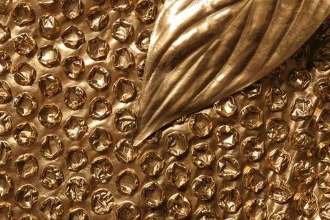 Painted leaf on golden bubble wrap, top view with space for text Stock Photos
