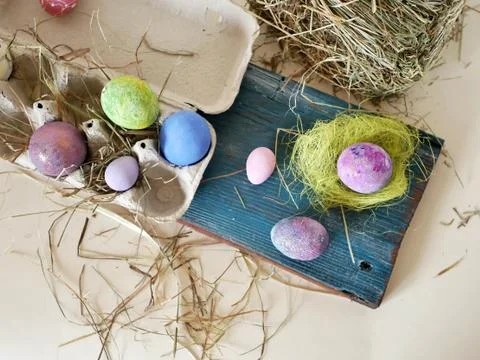 Painted multi-colored chicken and quail eggs in the package, Easter decor Stock Photos