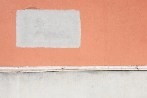 Painted over graffiti. White rectangle of censorship on an orange wall. 写真素材