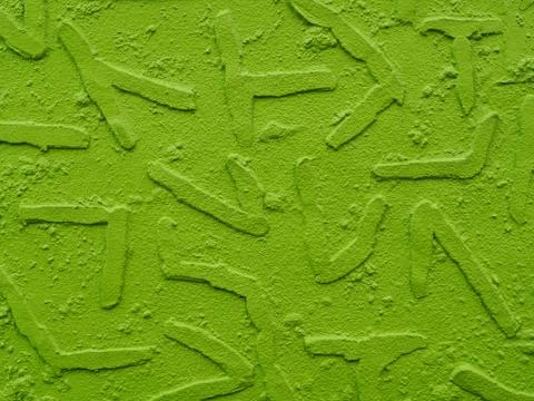 Painted plaster wall background with geometric shapes extruding , neon green. 写真素材