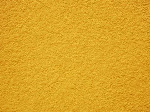Painted plaster wall background, Mustard yellow pastel. Stock Photos