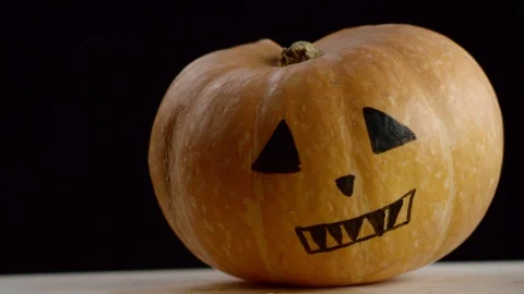 Painted pumpkin, black background Stock Footage 108560039
