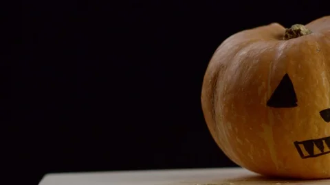 Painted pumpkin, camera moves from left to the right, black background Stock Footage 108560638