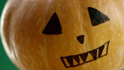 Painted pumpkin close-up, green background Stock Footage 108559425