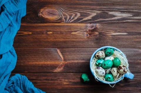 Painted quail eggs in a cup rustic wooden background Stock Photos