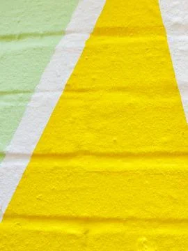 Painted real brick wall surface as background. Colors: yellow and faded gre.. Stock Photos