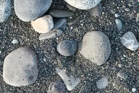 Painted smiley on a pebble stone on a beach on a Sunny day Stock Photos