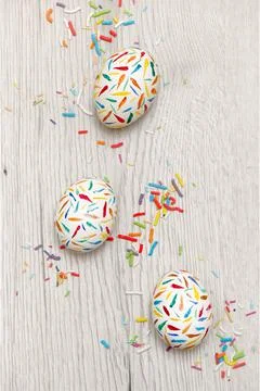 Painted Sprinkle Easter Eggs on white table Stock Photos