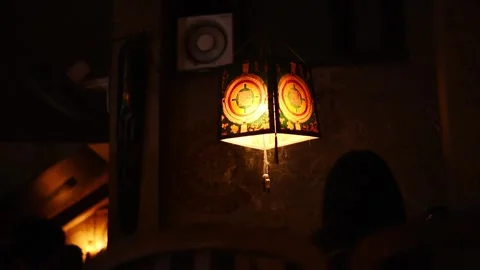 Painted Tibetan-style paper lantern glows with mandala motifs inside Snowman Stock Footage 344530448