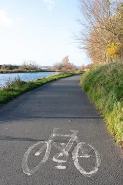 Painted white Cycle path sign on a tarmac cycle lane Stock Photos
