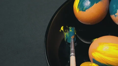 Painted Yellow-Blue Easter Eggs are Spinning Stock Footage 171469471