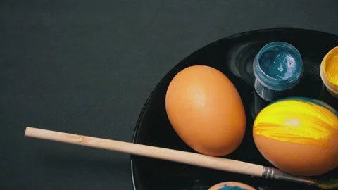 Painted Yellow-Blue Easter Eggs are Spinning Stock Footage 171608313