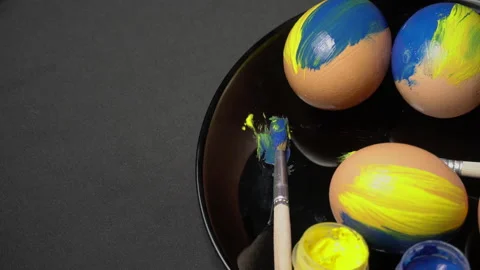 Painted Yellow-Blue Easter Eggs are Spinning Stock Footage 171639517