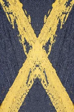 Painted Yellow Cross Painted yellow cross on a road Copyright: xZoonar.com... Stock Photos