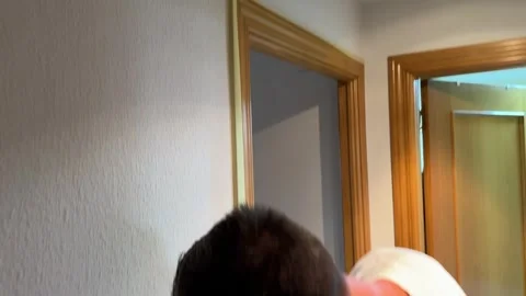 Painter applying masking tape on wall before painting Video stock 341362927