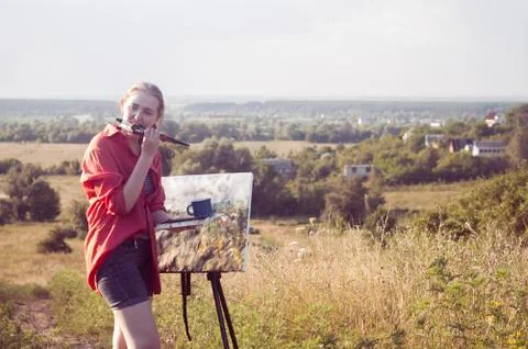 Painter with brush in her mouse Stock Photos