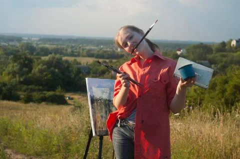 Painter with brush in her mouse Stock Photos