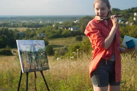 Painter with brush in her mouse Stock Photos