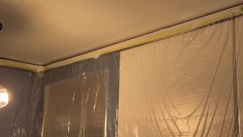 Painter carefully applying white paint to a ceiling with a brush Video stock 341363367