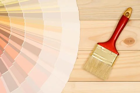 A painter is choosing a paint shade for the interior of the house's walls. .. Stock Photos