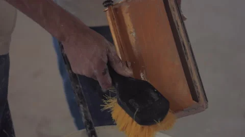 Painter cleaning his tools with brush Stock Footage 55143404