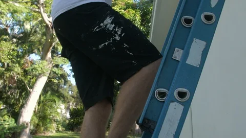 Painter Climbs Down Ladder After Spraying Primer Stock Footage 95485294