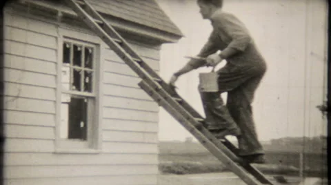 Painter climbs ladder at home construction 1950s vintage film home movie 947 Stock Footage 46990918