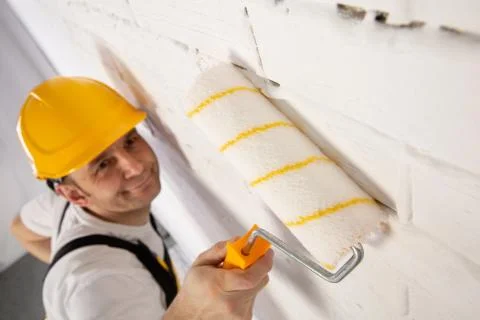 Painter on a construction site while doing his job. Fotos de archivo