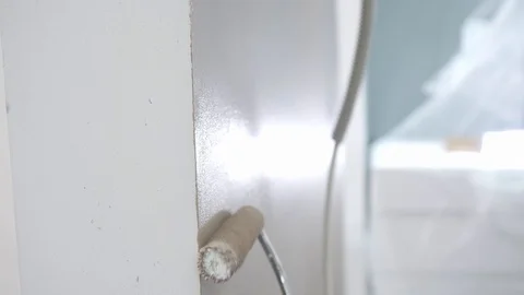 Painter covers white flat wall with brown paint closeup Video stock 124608107