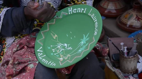 A painter decorating a plate made of clay in the famous Maison de poterie. Stock Footage 49678897