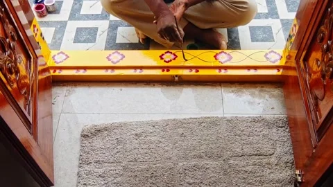 Painter Designing Leaf branch on Doorstep at residential home, hyderabad Stock Footage 335412279