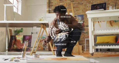 Painter dipping brush, applying orange circles on studio canvas while HUD Stock Footage 332275629