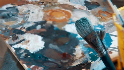 The painter dips a brush in oil to paint a picture Stock Footage 116414078