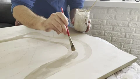 Painter drawing on canvas using paintbrush and beige oil paint Video stock 284341632