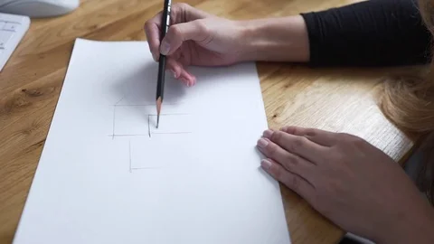 Painter draws by pencil and drawings become reality, designer draws the draught Stock Footage