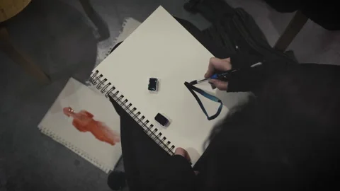 The painter draws a sketch on paper Stock Footage 265087640