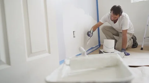 Painter with gloves painting the wall edge with brush. Stock Footage 129140030