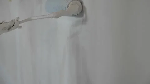 Painter hand holding roller brush painting new white wall, diy interior ext.. Stock Footage 274922378