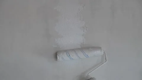 Painter hand holding roller brush painting new white wall, diy interior ext.. Stock Footage 274922714