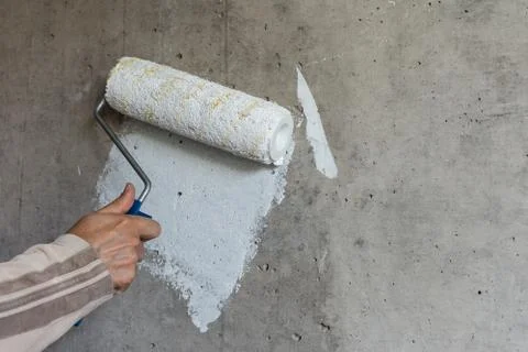 Painter hand with a paint roller Stock Photos