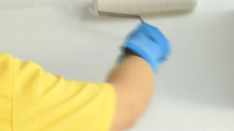 Painter hand with roller painting wall Stock Footage 56361376