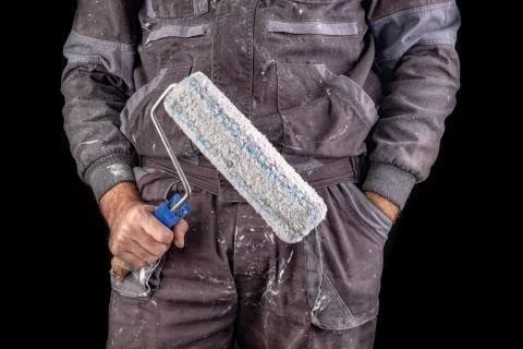 Painter holding paint rollers in his hand. Accessories for small home repairs Stock Photos