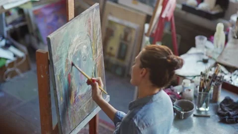 Painter making abstract portrait on canvas Stock Footage 142670114