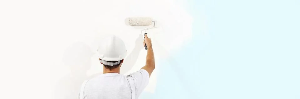 Painter man at work with a paint roller isolated , web banner, wall painting Stock Photos