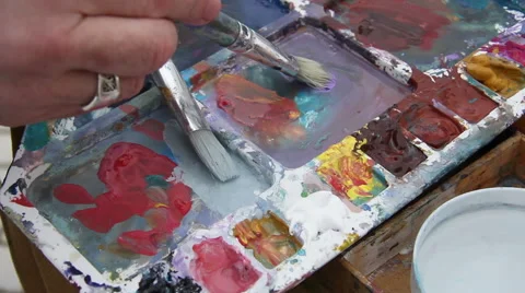 Painter mixes paint on the palette Stock Footage 61571972