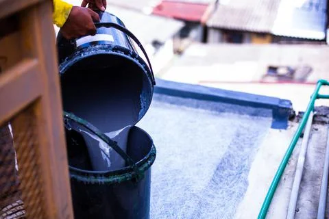 Painter is mixing waterproofing solution. Stock Photos