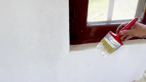 Painter Painting Window and Wall of Newly Constructed House Stock Footage 339530292