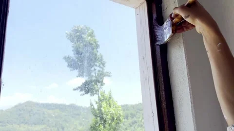 Painter Painting Window and Wall of Newly Constructed House Stock Footage 339530361