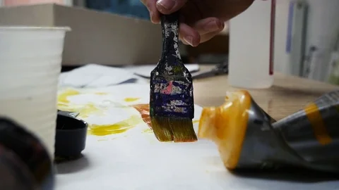 The painter paints a brush Stock Footage 98453225